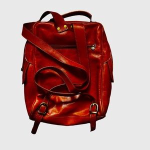 Leather backpack in good condition with some stains.